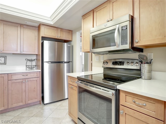 kitchen featuring light brown cabinets, light tile floors, a raised ceiling, crown molding, and stainless steel appliances