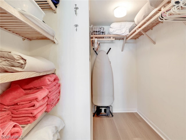 spacious closet with hardwood / wood-style floors