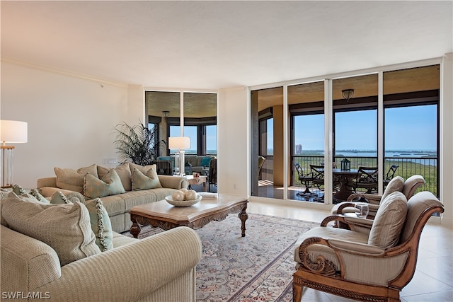 living room featuring a water view, expansive windows, and light tile patterned floors