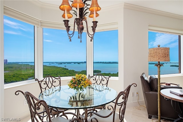 sunroom / solarium featuring a water view and a notable chandelier