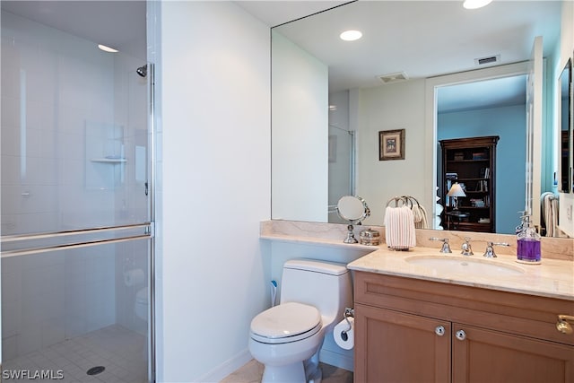 bathroom featuring tile patterned flooring, vanity, toilet, and an enclosed shower