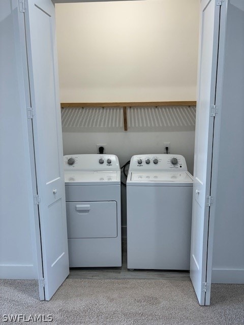 laundry area with laundry area, separate washer and dryer, and baseboards