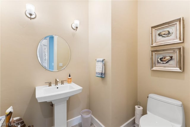 4142 Bay Beach Ln Unit 206, Fort Myers Beach, FL 33931 - half bathroom featuring toilet and baseboards