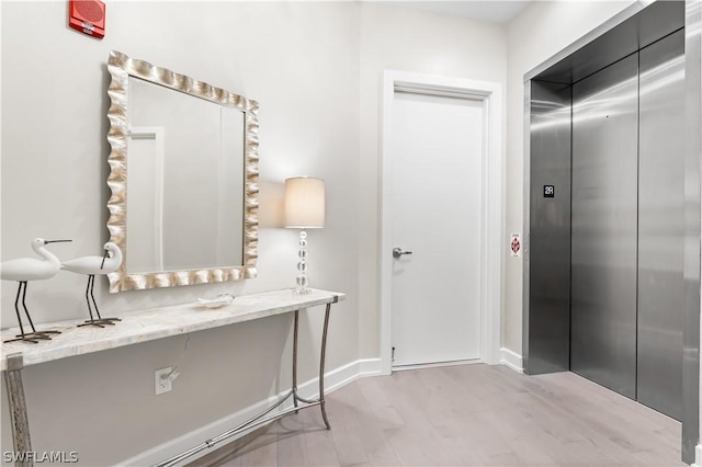 4142 Bay Beach Ln Unit 206, Fort Myers Beach, FL 33931 - bathroom featuring elevator and wood finished floors