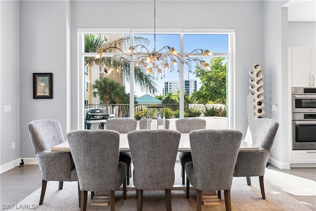 dining room with hardwood / wood-style floors and a notable chandelier