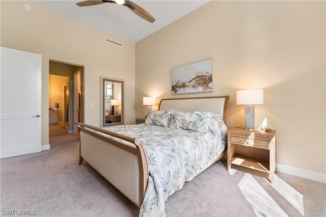 carpeted bedroom with ceiling fan and high vaulted ceiling