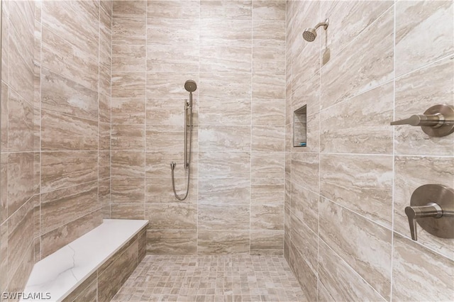 bathroom with tiled shower