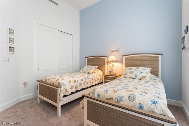 bedroom with a closet and light colored carpet