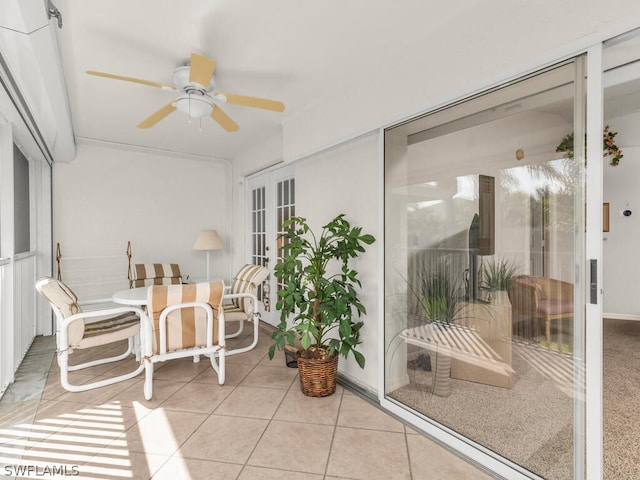 sunroom featuring ceiling fan and french doors