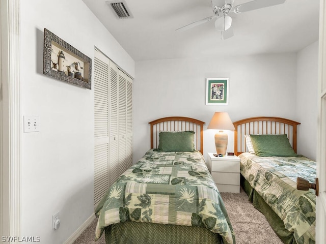 carpeted bedroom with a closet and ceiling fan