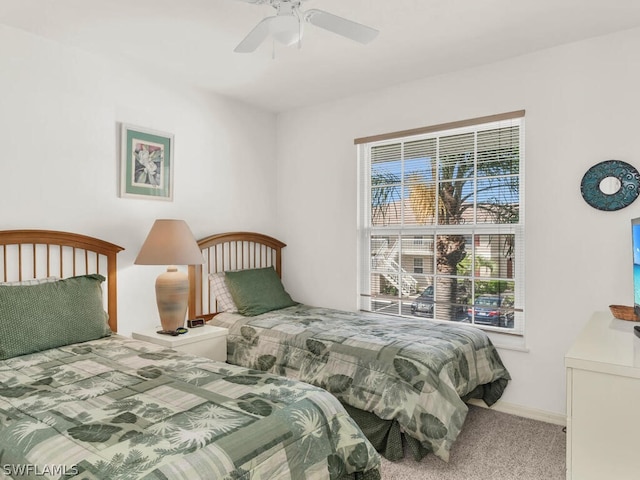 bedroom with ceiling fan and light colored carpet