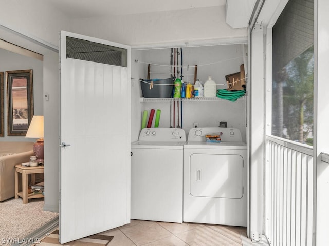 laundry room featuring washing machine and clothes dryer and light tile floors