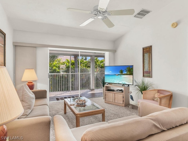 carpeted living room with ceiling fan