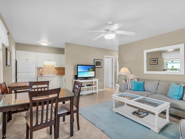 living room with light tile patterned flooring, ceiling fan, and sink