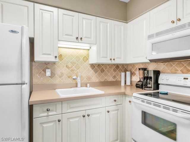 kitchen featuring backsplash, sink, white cabinets, and white appliances