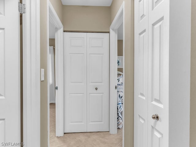 corridor with light tile patterned floors