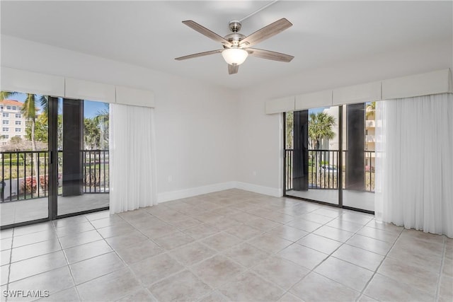 tiled empty room featuring a wealth of natural light and ceiling fan