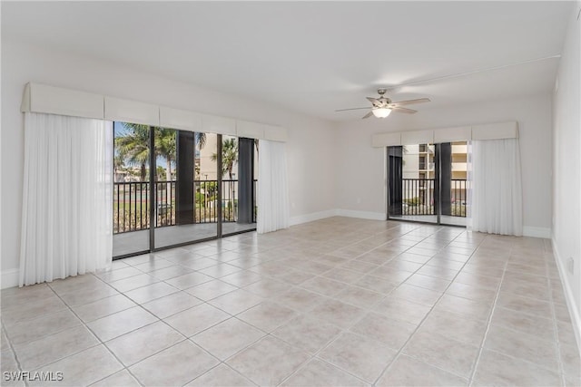 spare room featuring ceiling fan and light tile patterned floors