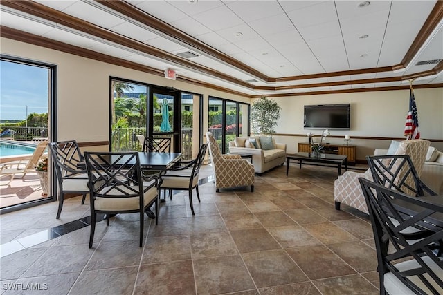 interior space featuring a tray ceiling and crown molding