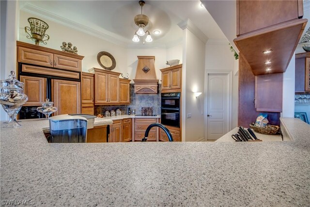 kitchen featuring custom range hood, tasteful backsplash, ornamental molding, sink, and ceiling fan