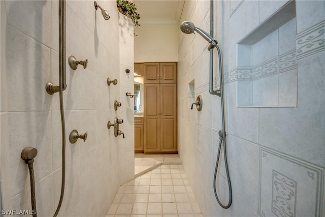 bathroom featuring ornamental molding, a tile shower, tile walls, and tile patterned floors