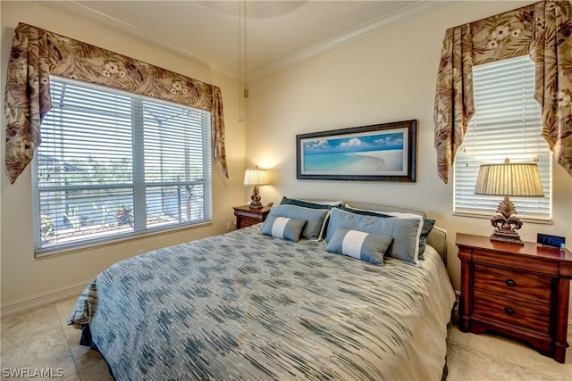 bedroom with crown molding and baseboards