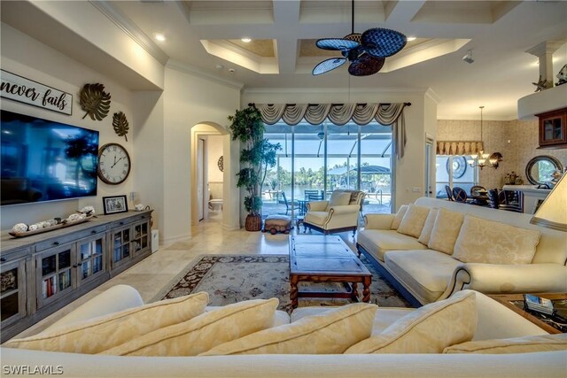 tiled living room with coffered ceiling, ceiling fan with notable chandelier, beam ceiling, and crown molding