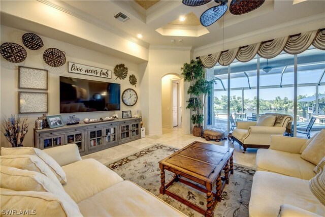 living room featuring light tile patterned floors, crown molding, coffered ceiling, ceiling fan, and a towering ceiling