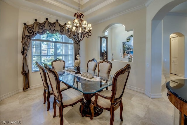 dining room with baseboards, arched walkways, a raised ceiling, and ornamental molding