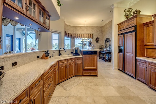 kitchen featuring crown molding, brown cabinetry, paneled fridge, and a sink