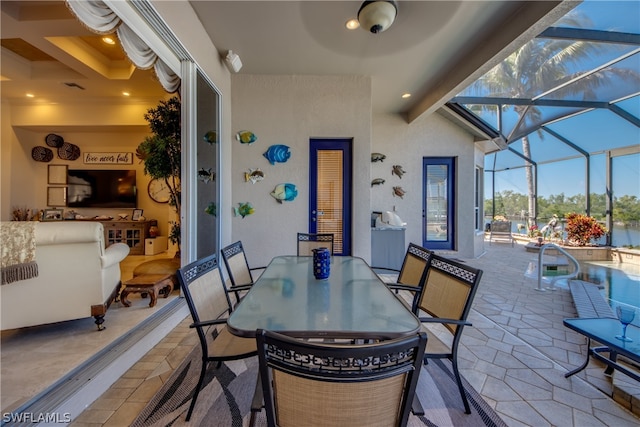 view of patio / terrace featuring glass enclosure