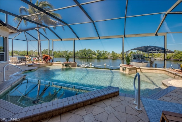 view of pool with glass enclosure, an in ground hot tub, a patio, and a water view