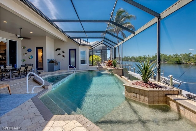 outdoor pool featuring a water view, glass enclosure, ceiling fan, and a patio