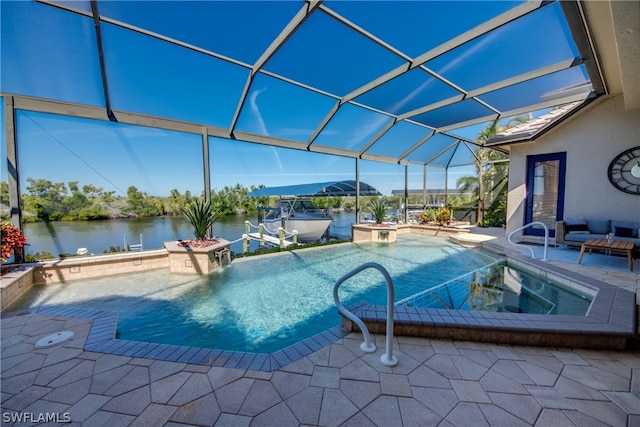 view of swimming pool featuring a patio area, a water view, pool water feature, glass enclosure, and a jacuzzi