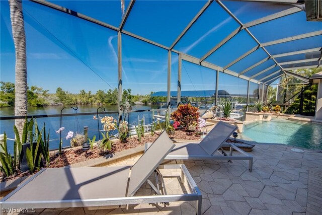 view of patio / terrace with glass enclosure and a water view