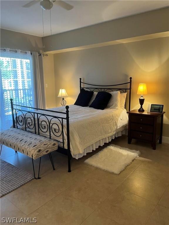 tiled bedroom with a ceiling fan