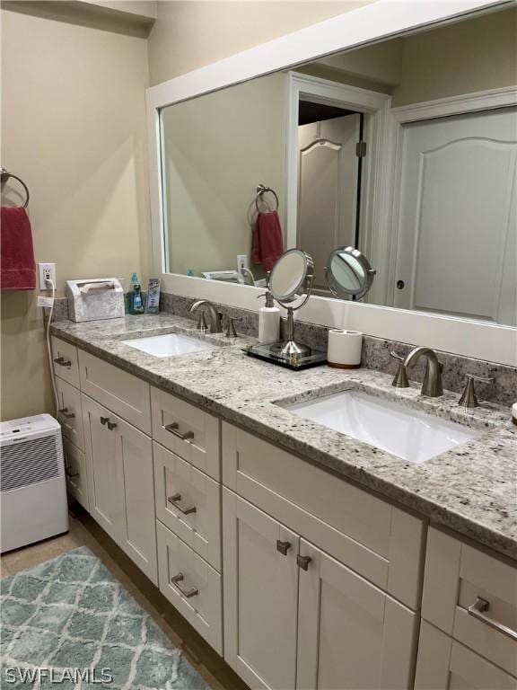 bathroom with a sink and double vanity