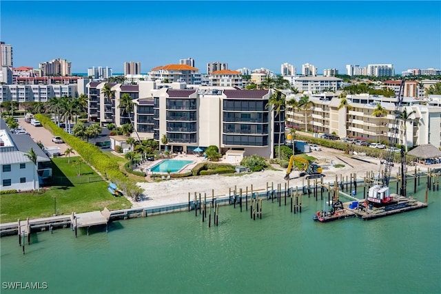 birds eye view of property featuring a view of city and a water view