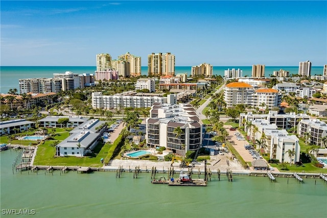 birds eye view of property with a view of city and a water view