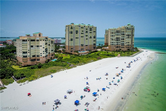 bird's eye view with a water view, a city view, and a view of the beach