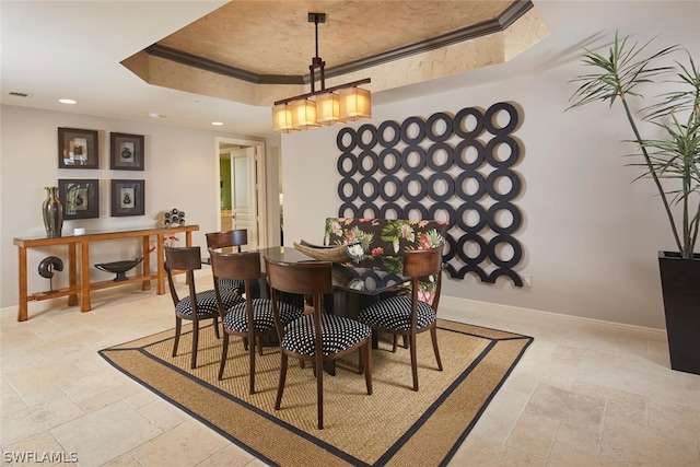 dining area featuring a raised ceiling