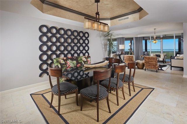 dining room featuring a tray ceiling and a chandelier