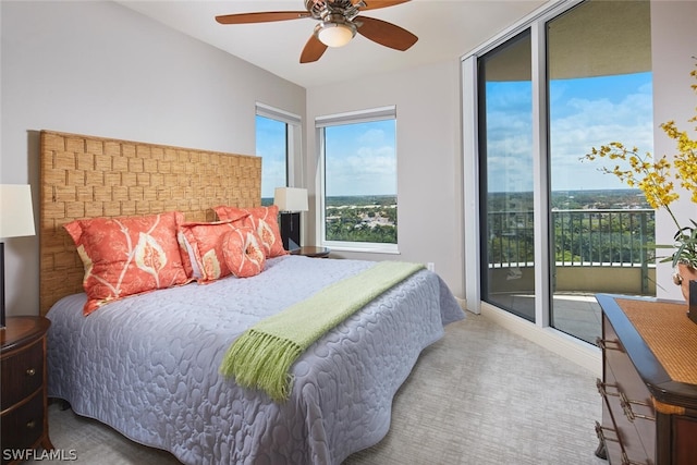 carpeted bedroom with ceiling fan and access to outside