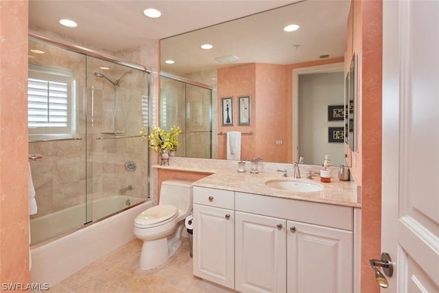 full bathroom featuring tile patterned floors, vanity, combined bath / shower with glass door, and toilet