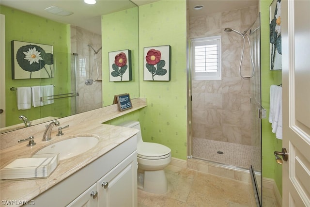 bathroom with tile patterned flooring, a shower with door, vanity, and toilet