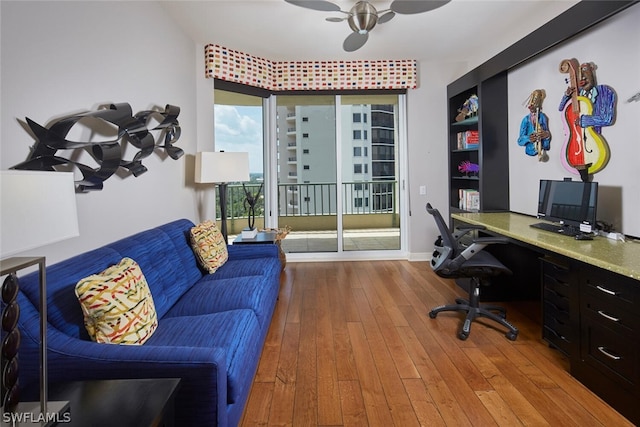 office space with light wood-type flooring and built in desk