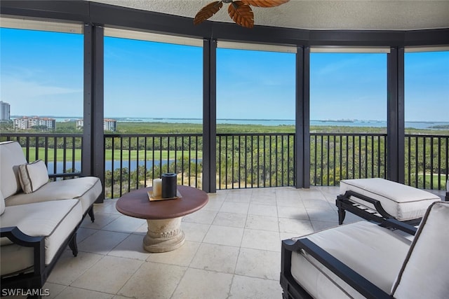 sunroom / solarium with a wealth of natural light and ceiling fan