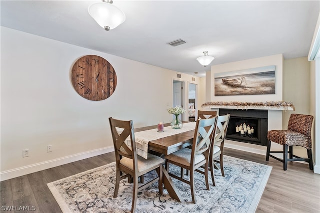 dining space with hardwood / wood-style floors