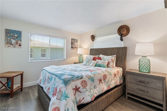 bedroom with dark hardwood / wood-style flooring