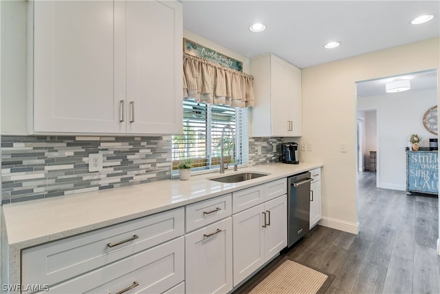 kitchen featuring white cabinetry, dark hardwood / wood-style floors, sink, and tasteful backsplash